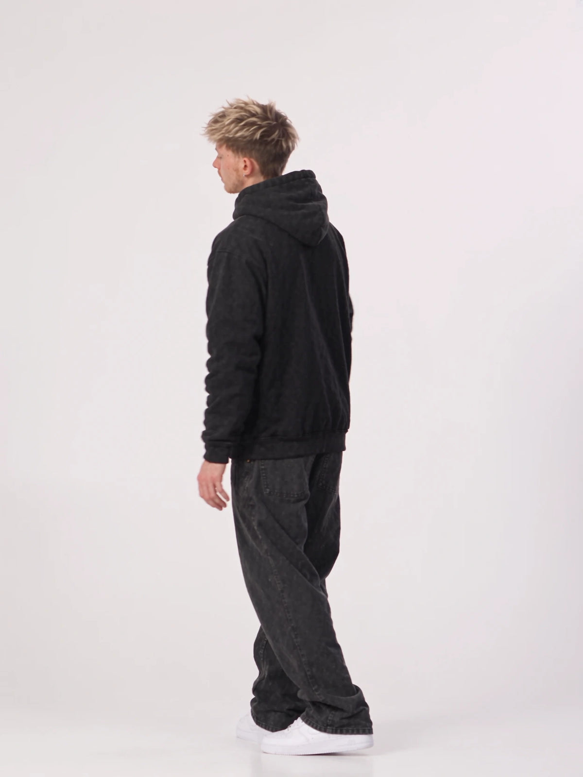Chase wearing a JSCA hoodie in a white studio