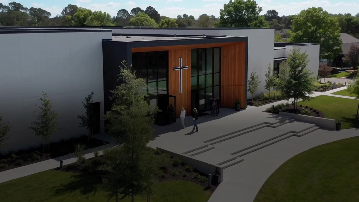 A modern church and its cross in daylight